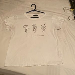 white large t shirt, “no rain, no flowers”